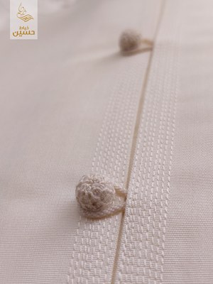 Close-up of the hand-finished cord button on the placket