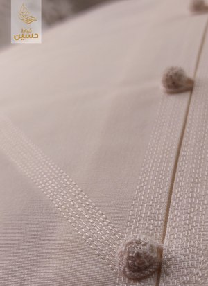 Close-up of cord buttons and topstitching on the fabric