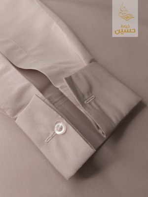 Close-up of the sleeve placket button, tighter crop