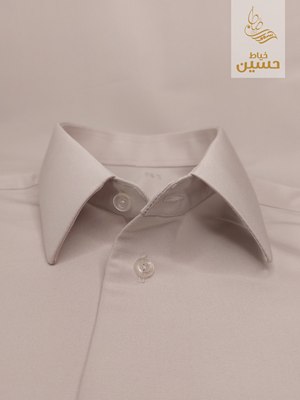 Close-up of the pointed spread collar with double button placket